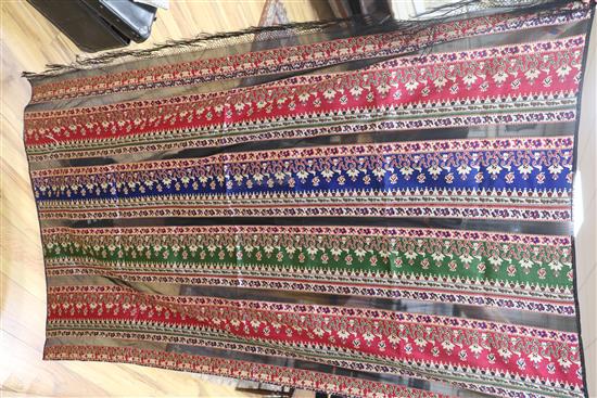 A Victorian woven silk shawl, four others and a Norwich shawl